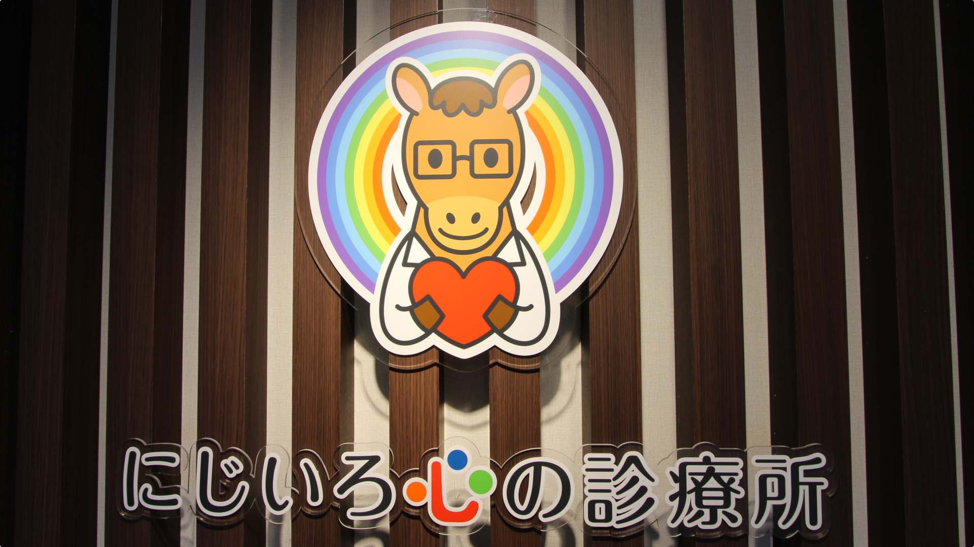 待合室の壁に掲げられている「にじいろ心の診療所」の看板